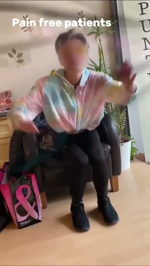 Patient moving her arms freely at the clinic after treatment